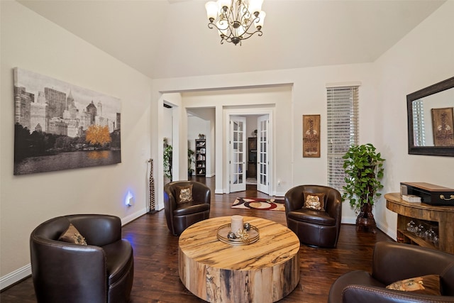 living room featuring dark wood-type flooring and an inviting chandelier