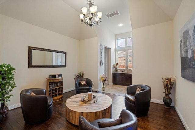 living room with an inviting chandelier, dark hardwood / wood-style floors, and high vaulted ceiling