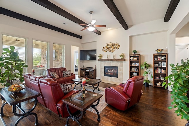 living room featuring dark wood-type flooring, ceiling fan, and a fireplace