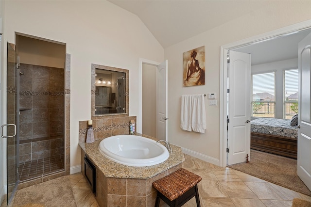 bathroom with tile patterned flooring, vaulted ceiling, and independent shower and bath