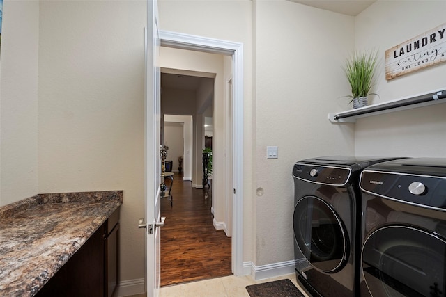 laundry room featuring tile patterned floors and washer and clothes dryer