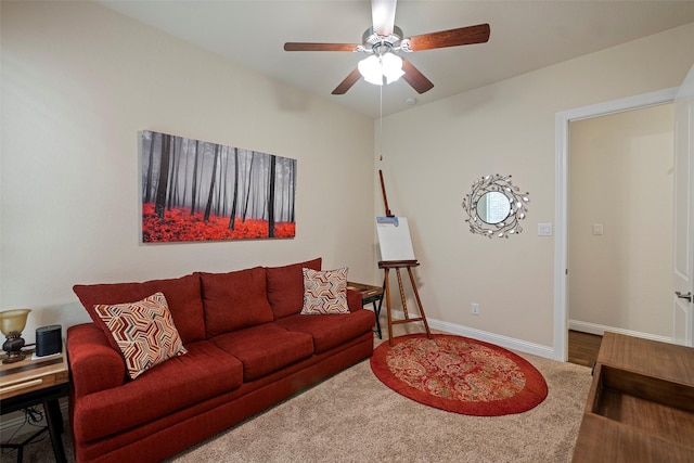 carpeted living room with ceiling fan