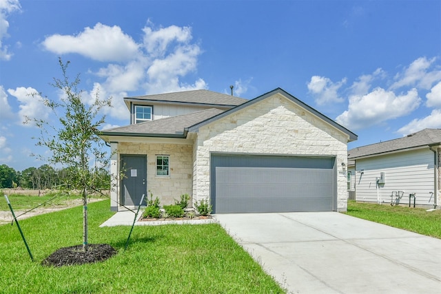 1312 Cypress Ln, Dayton, TX 77535 - view of front of property featuring stone siding, an attached garage, a front lawn, driveway, and a shingled roof