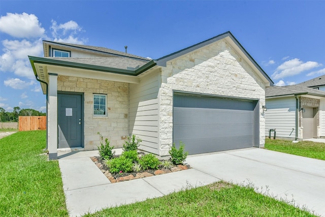 1312 Cypress Ln, Dayton, TX 77535 - view of front of property featuring stone siding, an attached garage, concrete driveway, and a shingled roof