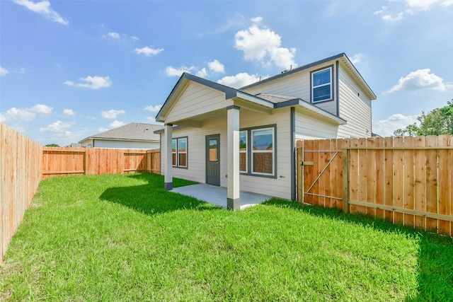 1312 Cypress Ln, Dayton, TX 77535 - rear view of house with a fenced backyard, a gate, and a patio area