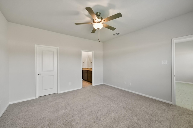 1312 Cypress Ln, Dayton, TX 77535 - unfurnished bedroom with light carpet, ensuite bath, and ceiling fan