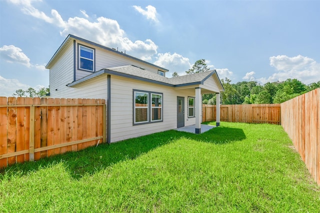1312 Cypress Ln, Dayton, TX 77535 - rear view of property with a fenced backyard, roof with shingles, and a patio