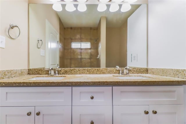 bathroom with vanity and tiled shower