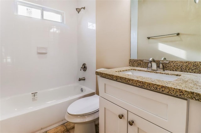 bathroom featuring washtub / shower combination, vanity, and toilet