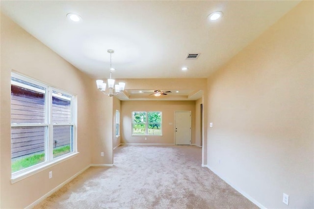 spare room featuring recessed lighting, light colored carpet, visible vents, baseboards, and ceiling fan with notable chandelier