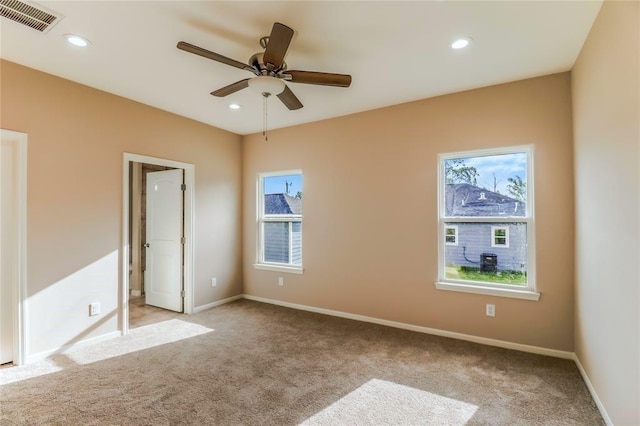 unfurnished room featuring recessed lighting, light carpet, and visible vents