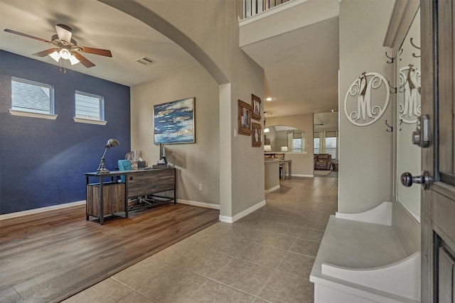 entryway featuring light tile patterned flooring and ceiling fan