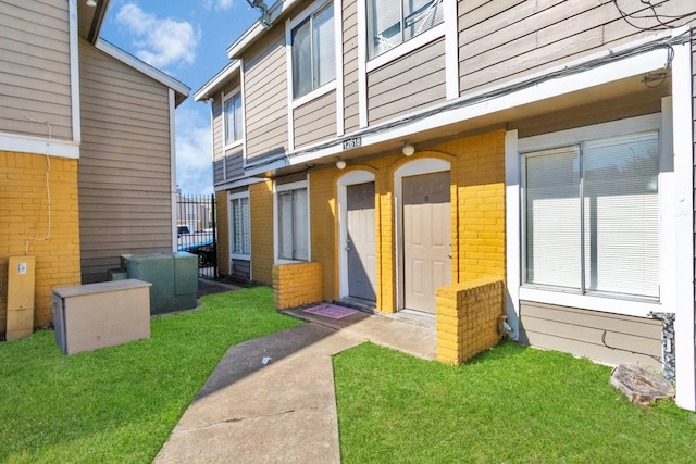 doorway to property featuring a yard