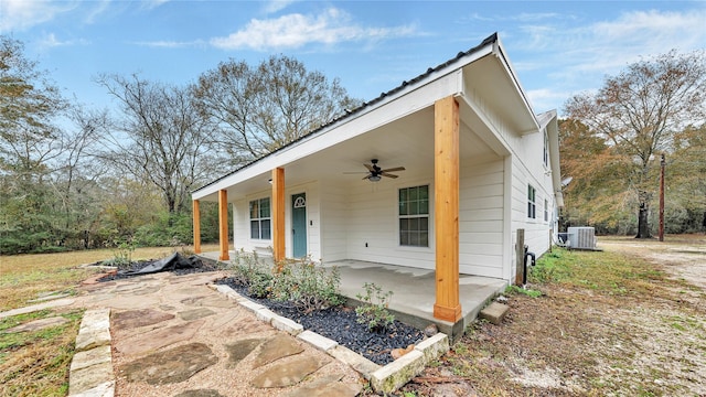 view of front of home with a porch, central AC, ceiling fan, and a patio area