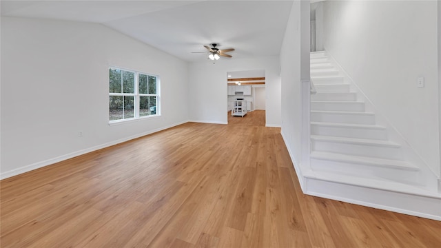 unfurnished living room featuring ceiling fan, vaulted ceiling, and light hardwood / wood-style flooring