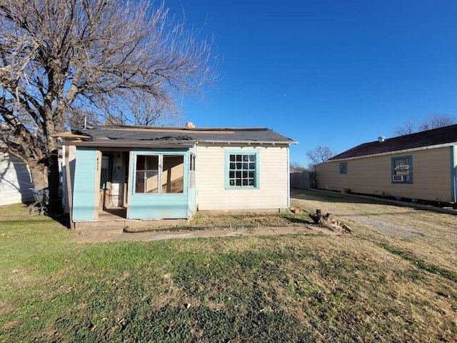 back of house with a lawn