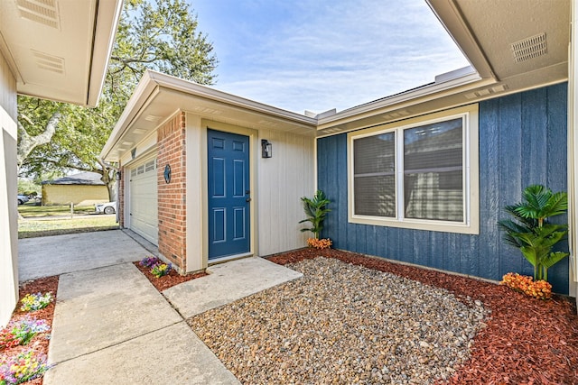 view of exterior entry with a garage