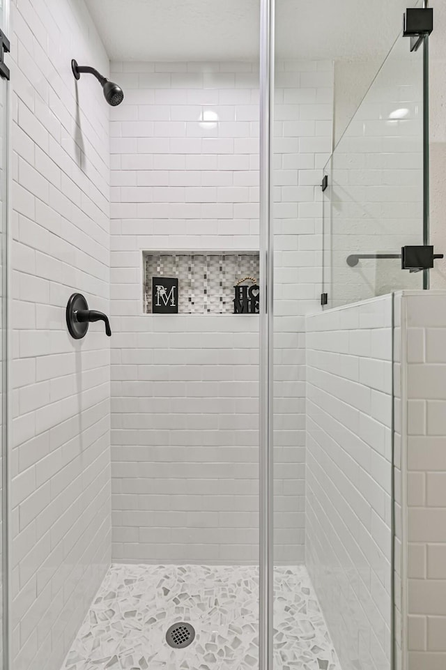 bathroom with a shower with door