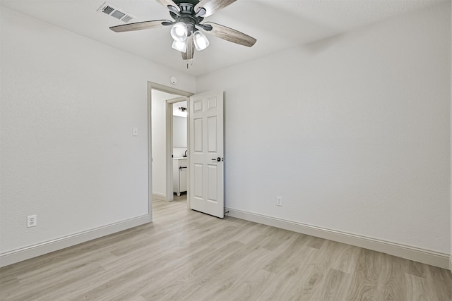 empty room with ceiling fan and light wood-type flooring