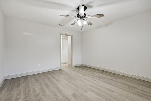 unfurnished room with ceiling fan and light hardwood / wood-style floors