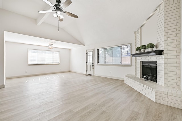 unfurnished living room featuring high vaulted ceiling, a fireplace, beamed ceiling, ceiling fan, and light hardwood / wood-style floors