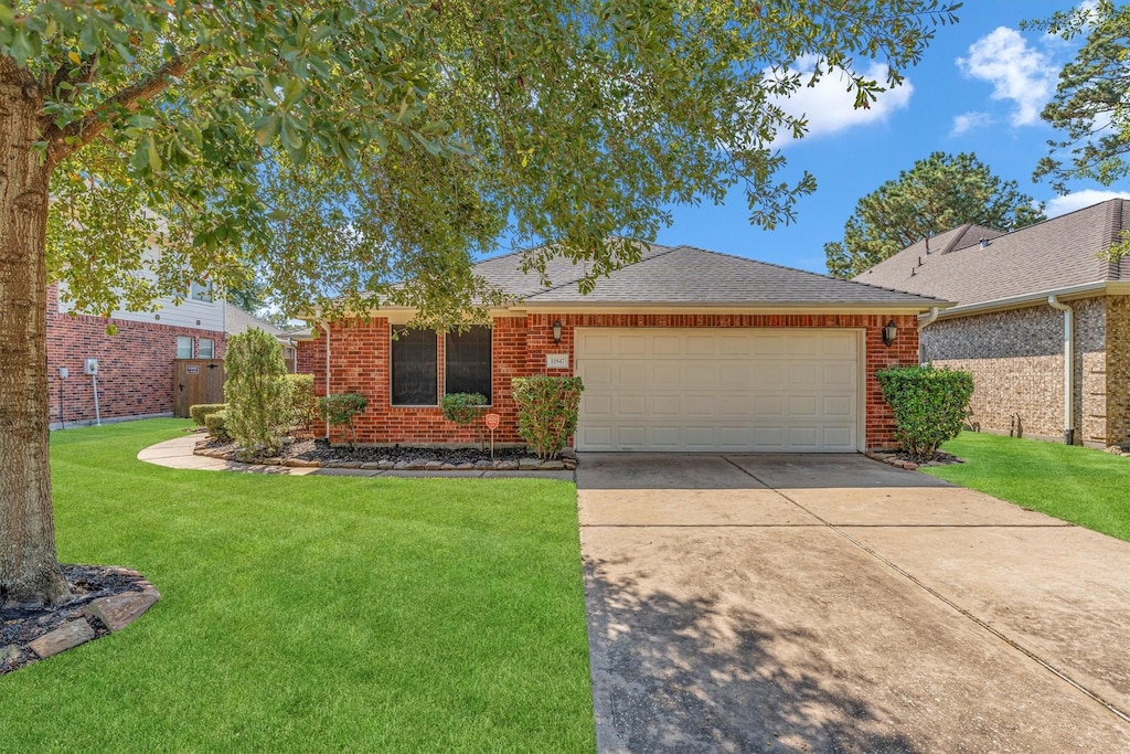 ranch-style home featuring a garage and a front yard