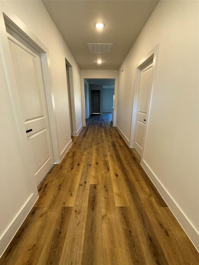 hallway with wood-type flooring