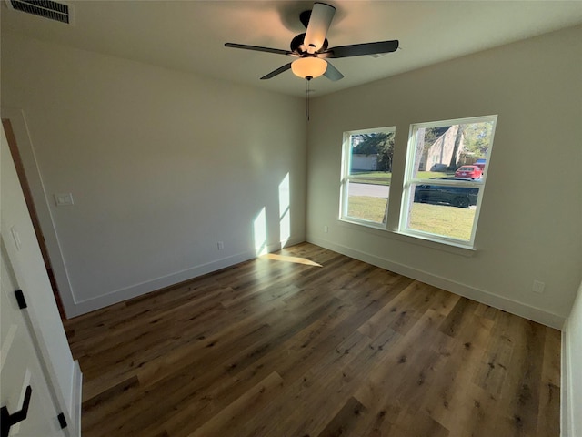 unfurnished room featuring dark hardwood / wood-style flooring and ceiling fan