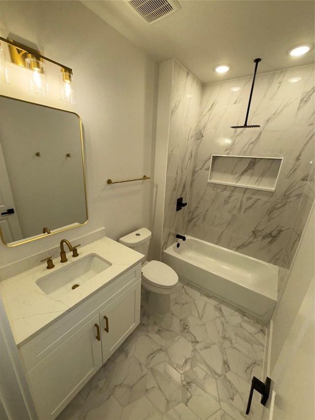 full bathroom with tiled shower / bath, vanity, and toilet