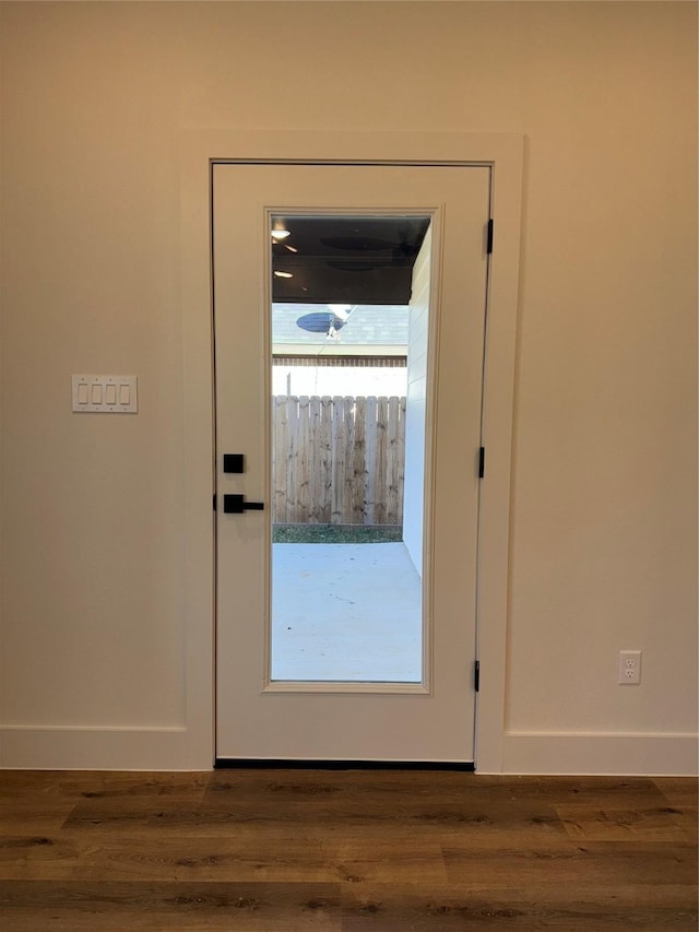 doorway featuring dark wood-type flooring