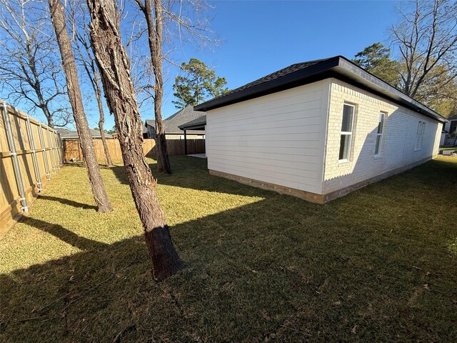 view of property exterior with a lawn