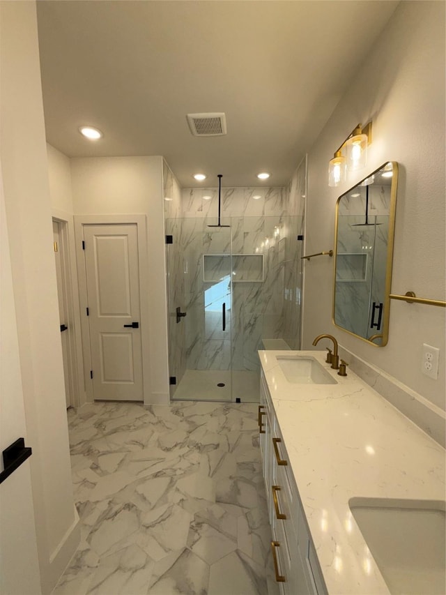 bathroom featuring vanity and a shower with shower door