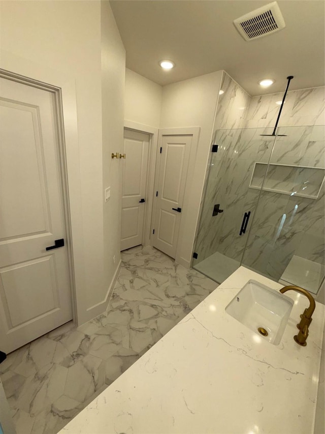 bathroom with sink and a shower with door