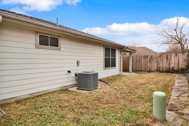 exterior space with a yard and central AC