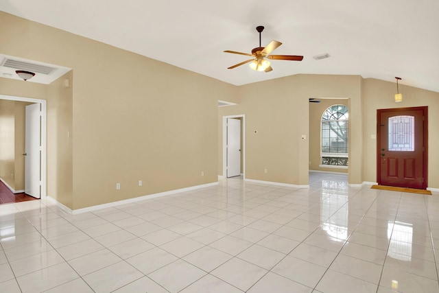 empty room with light tile patterned flooring, vaulted ceiling, and ceiling fan