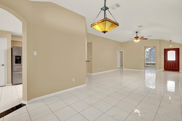 tiled empty room featuring lofted ceiling and ceiling fan