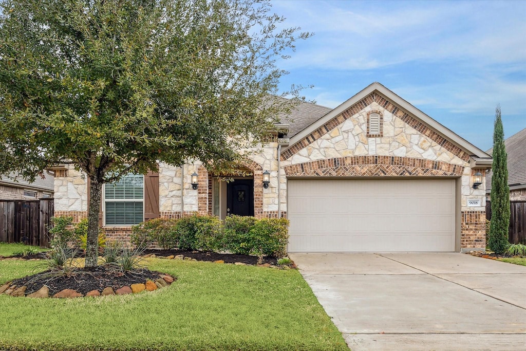 view of front of property with a garage and a front yard