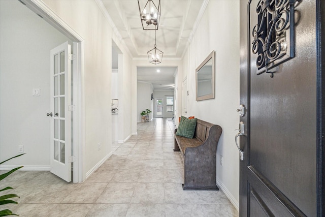 entrance foyer with french doors, ornamental molding, and a tray ceiling