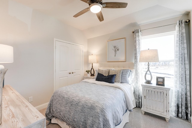 bedroom featuring ceiling fan, light carpet, and a closet