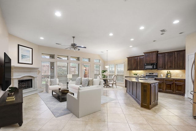 tiled living room with ceiling fan, lofted ceiling, a high end fireplace, and sink