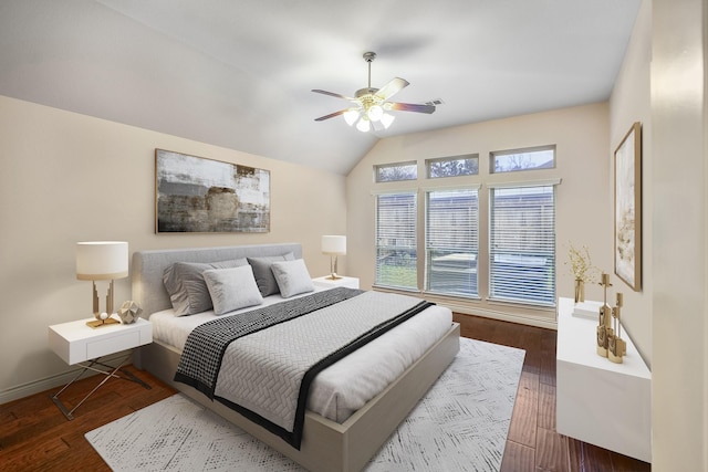 bedroom featuring dark wood-type flooring, ceiling fan, and vaulted ceiling