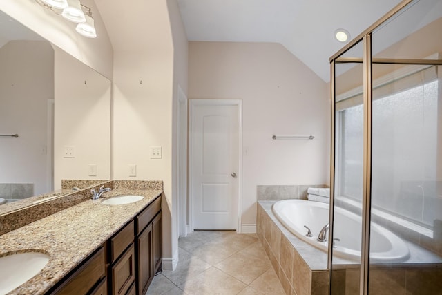 bathroom with vaulted ceiling, a relaxing tiled tub, tile patterned floors, and vanity