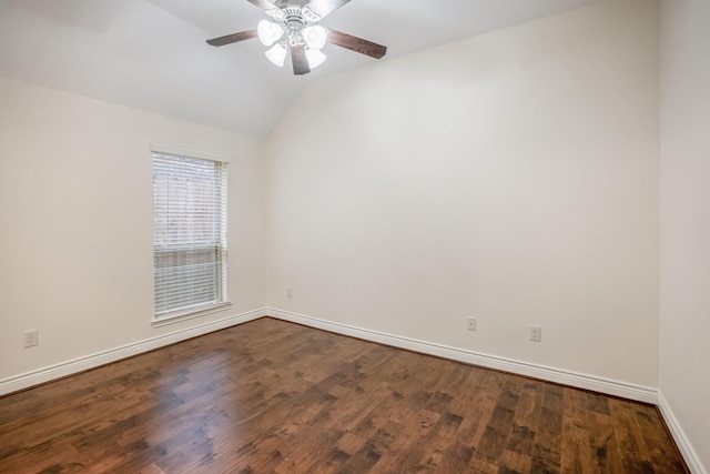 empty room with ceiling fan, lofted ceiling, and dark hardwood / wood-style flooring