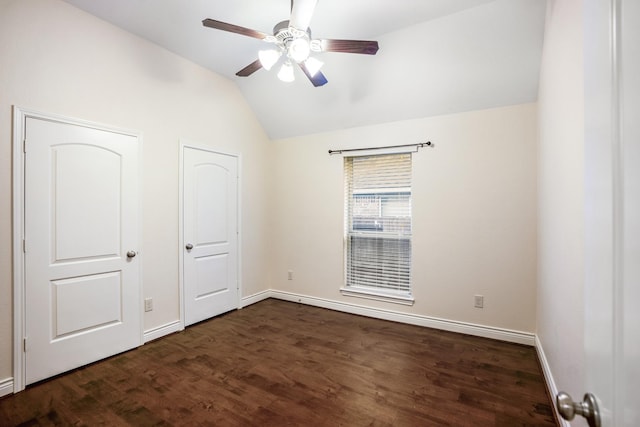 unfurnished bedroom featuring vaulted ceiling, dark hardwood / wood-style flooring, and ceiling fan