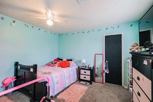 bedroom featuring ceiling fan, light colored carpet, and a textured ceiling