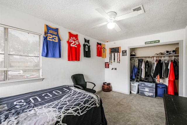 bedroom with carpet floors, a closet, and a textured ceiling