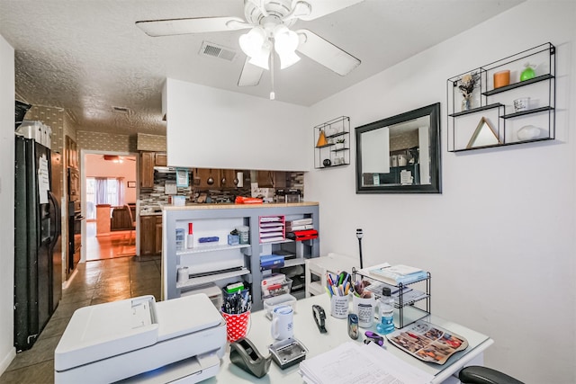 interior space featuring ceiling fan and black fridge with ice dispenser