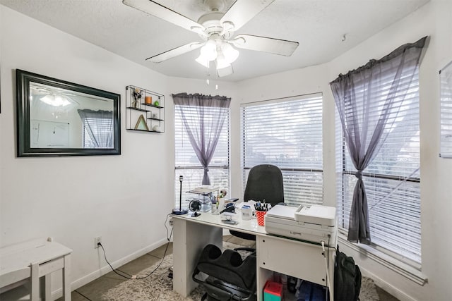 tiled home office featuring ceiling fan