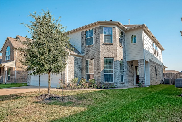 view of front of home with cooling unit, a garage, and a front lawn