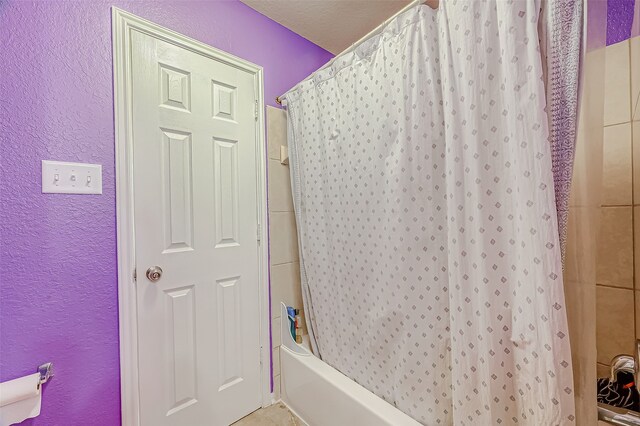 bathroom with shower / tub combo with curtain